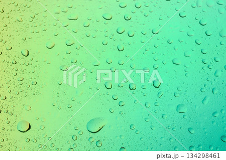 Abstract macro texture of clear water droplets on a soft green gradient background, representing fresh condensation, rain, or dew on a glass surface. Abstract macro texture of clear water droplets on a soft green gradient background, representing fresh condensation, rain, or dew on a glass surface. 134298461