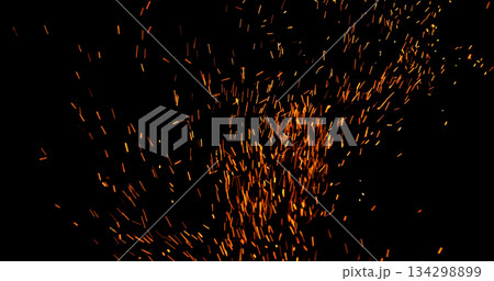Realistic fire sparks flying through the air, isolated on a black background. Perfect as a cinematic VFX overlay, fire particles effect or visual element. Realistic fire sparks flying through the air, isolated on a black background. Perfect as a cinematic VFX overlay, fire particles effect or visual element. 134298899