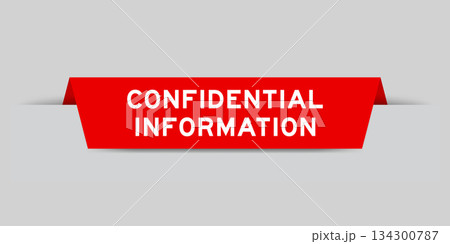 Red color inserted label with word confidential information on gray background 134300787