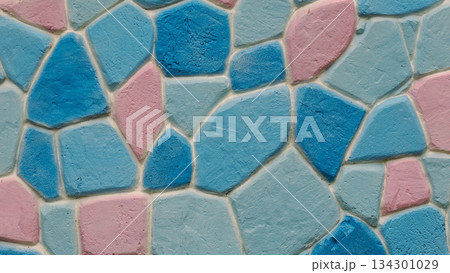 Close-up of decorative wall texture with geometric, irregular pastel-colored blocks (blue, light blue, pink). Close-up of decorative wall texture with geometric, irregular pastel-colored blocks (blue, light blue, pink). 134301029
