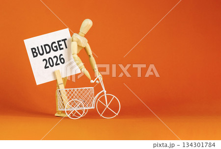 Budget 2026 symbol. Concept words Budget 2026 on beautiful white card. Beautiful orange paper background. Businessman's model. Business and budget 2026 concept. Copy space. 134301784