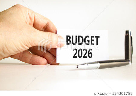 Budget 2026 symbol. Concept words Budget 2026 on beautiful white card. Beautiful white paper background. Businessman's hand. Business and budget 2026 concept. Copy space. 134301789