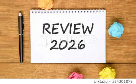 Review 2026 symbol. Concept words Review 2026 on beautiful white note. Beautiful wooden background. Black pen. Colored paper. Business and review 2026 concept. Copy space. 134301878
