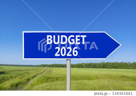Budget 2026 symbol. Concept words Budget 2026 on beautiful blue road sign. Beautiful green grass field forest and blue sky background. Business and budget 2026 concept. Copy space. Budget 2026 symbol. Concept words Budget 2026 on beautiful blue road sign. Beautiful green grass field forest and blue sky background. Business and budget 2026 concept. Copy space. 134301881