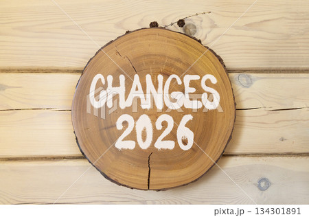 Changes 2026 symbol. Concept words Changes 2026 on beautiful wooden circle. Beautiful wooden wall background. Business and changes 2026 concept. Copy space. 134301891