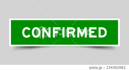 Green color square shape sticker label with word confirmed on gray background 134302061