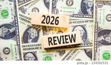 2026 Review symbol. Concept words 2026 Review on beautiful wooden blocks. Beautiful dollar bills background. Dollar bills. Business and 2026 review concept. Copy space. 2026 Review symbol. Concept words 2026 Review on beautiful wooden blocks. Beautiful dollar bills background. Dollar bills. Business and 2026 review concept. Copy space. 134302531
