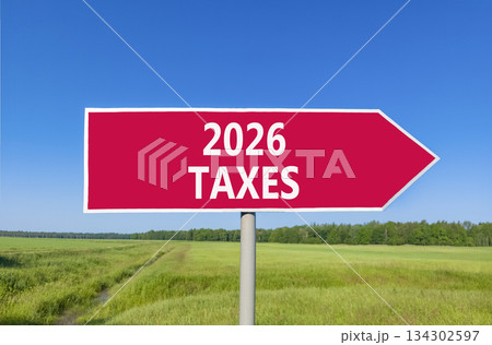 2026 taxes new year symbol. Concept words 2026 taxes on beautiful red road sign. Beautiful green grass field forest and blue sky background. Business and 2026 taxes new year concept. Copy space. 2026 taxes new year symbol. Concept words 2026 taxes on beautiful red road sign. Beautiful green grass field forest and blue sky background. Business and 2026 taxes new year concept. Copy space. 134302597