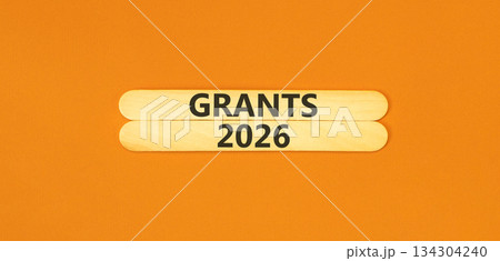 Grants 2026 symbol. Concept words Grants 2026 on beautiful wooden sticks. Beautiful orange paper background. Business and grants 2026 concept. Copy space. 134304240