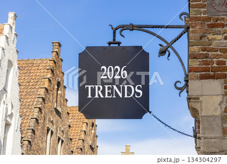 2026 Trends new year symbol. Concept words 2026 Trends on beautiful black road sign. Beautiful street and buildings in Brugge blue sky background. Business and 2026 Trends new year concept. Copy space 134304297
