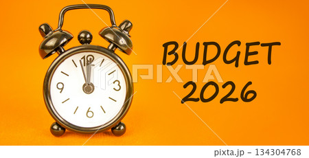 Budget 2026 symbol. Concept words Budget 2026 on beautiful orange paper. Beautiful orange paper background. Beautiful black alarm clock. Business and budget 2026 concept. Copy space. 134304768