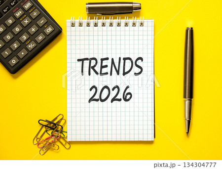 Trends 2026 new year symbol. Concept words Trends 2026 on beautiful white note. Beautiful yellow background. Black pen. Beautiful black calculator. Business Trends 2026 new year concept. Copy space. 134304777