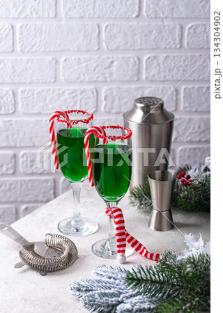 Christmas green cocktail punch with candy cane 134304902