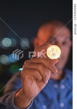 Man holding bitcoin coin investing in cryptocurrency future Man holding bitcoin coin investing in cryptocurrency future 134304985
