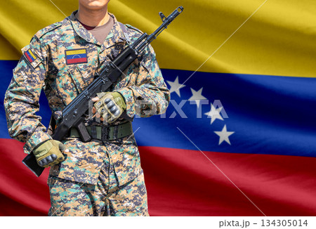 Venezuela flag with soldier holding assault rifle 134305014