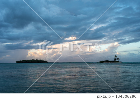 Sunset over two tropical motu on Tikehau Atoll, French Polynesia Sunset over two tropical motu on Tikehau Atoll, French Polynesia 134306290