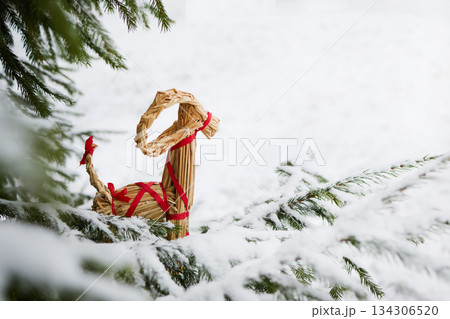 Julbock Christmas goat. Straw Goat in Snowy Pines 134306520