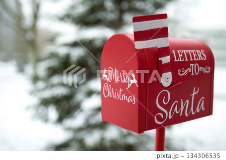 Santa's Mailbox in Snowy Scene. Red mailbox for letters to Santa, set in a snowy winter background Santa's Mailbox in Snowy Scene. Red mailbox for letters to Santa, set in a snowy winter background 134306535