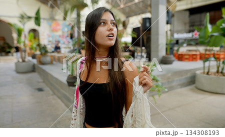 A Young Woman Engaging in Exploration of a Trendy Urban Space While Embracing Life A Young Woman Engaging in Exploration of a Trendy Urban Space While Embracing Life 134308193