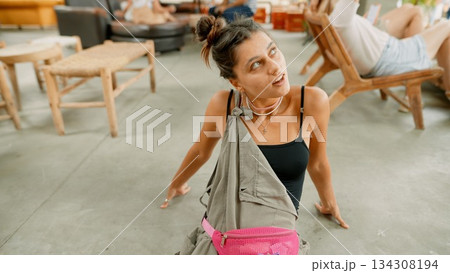 A Young Woman Posing in a Casual Yet Stylish Way at a Trendy and Modern Venue Spot 134308194