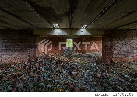 Abandoned interior of a desolate building with rubble and debris 134308203