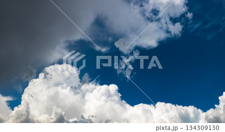 Majestic clouds drifting across expansive blue sky 134309130