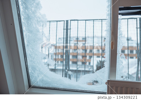 frost-covered, snow-covered window in modern house 134309221