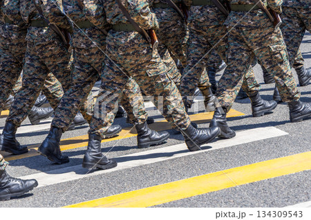Group of soldiers marching in camouflage uniforms outdoors Group of soldiers marching in camouflage uniforms outdoors 134309543