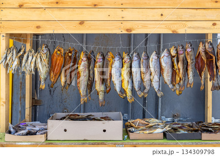 Dried smoked fish displayed in rustic outdoor market stall Dried smoked fish displayed in rustic outdoor market stall 134309798