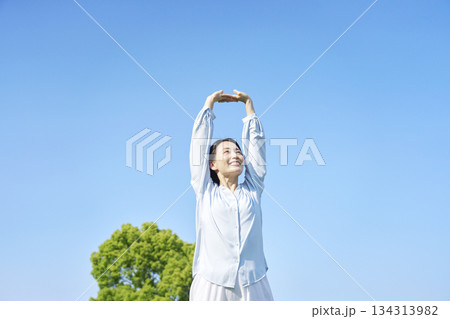 屋外で伸びをする女性 屋外で伸びをする女性 134313982
