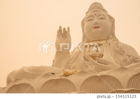 An iconic statue of Guanyin located in Wat Huay Pla Kang of Chiang Rai province of Thailand covered with bad air pollution (PM 2.5). PM2.5 levels meaning the air quality posed a health hazard. 134315125
