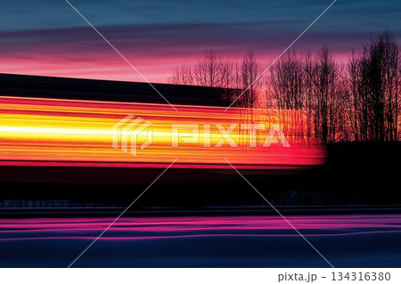 High-Speed Freight Train Moving Through Industrial Landscape at Sunset High-Speed Freight Train Moving Through Industrial Landscape at Sunset 134316380