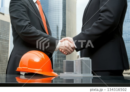Civil Engineers and Project Managers Shaking Hands at Construction Site with City Background Civil Engineers and Project Managers Shaking Hands at Construction Site with City Background 134316502