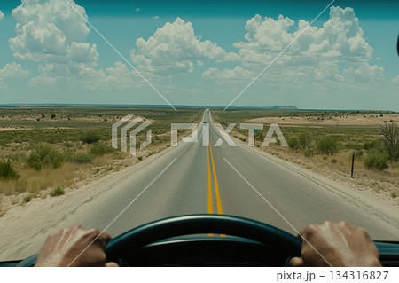 Driver's Perspective Looking Out Onto an Endless Open Road Under Blue Skies 134316827