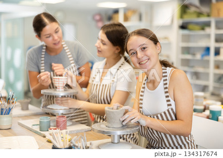 During master class, teen girl student sculpt from clay During master class, teen girl student sculpt from clay 134317674