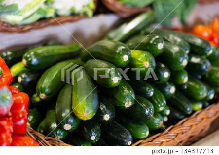 View of zucchini in a wicker basket, put up for sale in store 134317713
