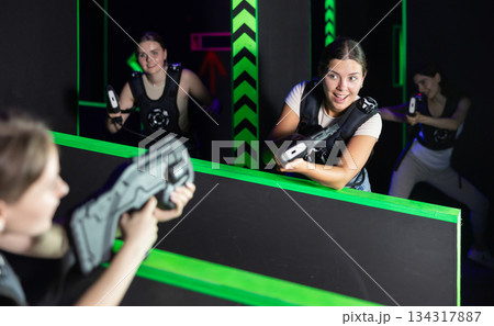Girls play laser tag, jokingly fight with light weapons 134317887
