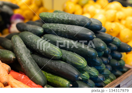 View of cucumbers in a wicker basket, put up for sale in store 134317979