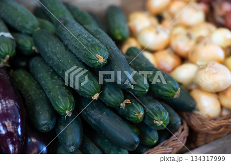 View of cucumbers in a wicker basket, put up for sale in store View of cucumbers in a wicker basket, put up for sale in store 134317999