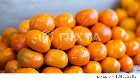 Ripe tangerines in a box on the market close up 134318203
