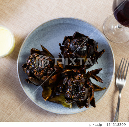 Fried or baked artichokes are dietary dish of Mediterranean cuisine 134318209