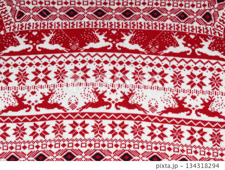 close-up of scandinavian knitwear reindeer, snowflakes, red and white ornament close-up of scandinavian knitwear reindeer, snowflakes, red and white ornament 134318294