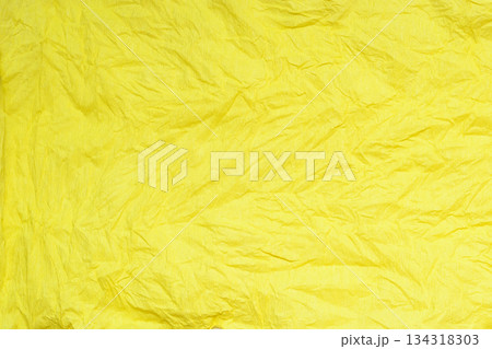 horizontal pattern of crumpled crepe paper in a very bright yellow color horizontal pattern of crumpled crepe paper in a very bright yellow color 134318303