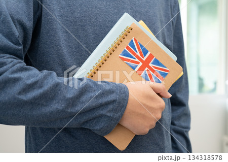 Learn English language, Asian teenage student hold book with flag in course at school. 134318578