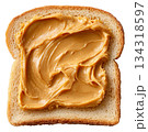 peanut butter on a slice of toast. 134318597