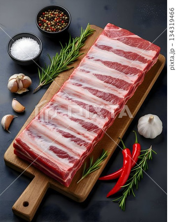 Raw Pork Belly Slabs on Wooden Cutting Board with Herbs 134319466