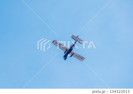 Small ultralight airplane with overhead wing and single propeller flying in sunset sky. Small ultralight airplane with overhead wing and single propeller flying in sunset sky. 134322013