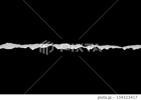 Ripped torn paper edges isolated on black background Ripped torn paper edges isolated on black background 134323417