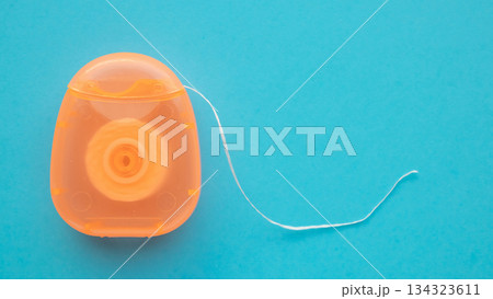 dental floss in case on blue background dental floss in case on blue background 134323611