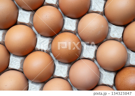 Fresh organic brown chicken eggs in cardboard tray 134323847